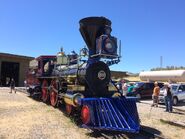 The locomotive sits outside the engine house.