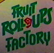 A logo for the fictitious Fruit Roll-Ups Factory seen in various commercials- the text is green and the Roll-Up standing in for the dash is red.
