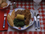 In the episode "The Checkbook", the logo's plate contains fried chicken, baked beans, corn on the cob, and either collard greens or spinach.