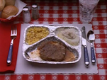 In the episode "All I Want for Christmas", the logo contains a TV dinner with Salisbury steak, corn, and mashed potatoes.