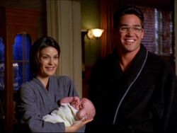 Lois and Clark with their baby