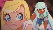 Talia puts a hand on Iris' shoulder