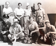 Live-action crew for YOU OUGHT TO BE IN PICTURES (1940). 1st row, kneeling: Michael Maltese (still in security guard uniform), Friz Freleng, Paul Collier, Paul Marron, Smokey Garner. 2nd row, standing: Jack Miller, Harold Soldinger, Johnny Burton, Henry Binder.