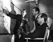 Bob McKimson with Warren Foster and Eddie Selzer (seated) during the production c. 1945