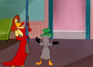 Daffy hands her a rifle so they can reenact a crime. He gets shot again.