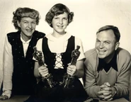 Chuck with his wife Dorothy (left) and his daughter Linda (middle) holding two Oscar statuettes that he won for "So Much for So Little” and “For Scent-imental Reasons”