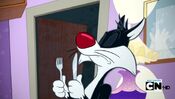 Sylvester preparing to eat Tweety.