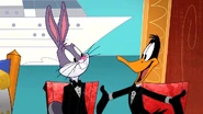 Daffy tries his best to get on Bugs's good side.