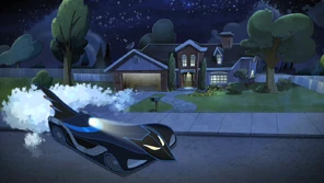 The driveway and front of the house in the dark.