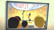 Daffy watching himself sing in his talent show on DVD.