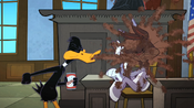 Daffy spits soda on Bugs in the courtroom.