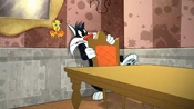 Tweety and Sylvester hiding behind a chair.