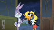 Bugs with Daffy, who is dressed like a young girl.