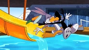 Daffy jumps in front of Bugs when he goes down the waterslide.