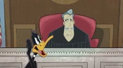 Daffy speaking to the courtroom judge.