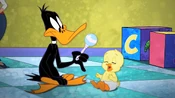 Daffy shakes the rattle, much to Zachary's delight.