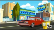 Tina driving on the wrong side of the road, in front of Copy Place