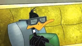 Daffy watching videos of his "painful" childhood.