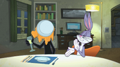 Bugs wipes his hand while Daffy lifts up a glass.