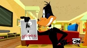 Daffy holding up his autograph.