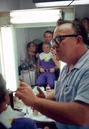 John Chambers does some final touches to Bill Mumy's Dr. Smith make-up while Jonathan Harris observes.