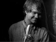 The boy suddenly appears in the mirror offering the Bloop a bananna.