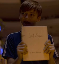 Will Robinson, holding up a copy of the memoir
