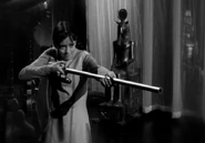 Penny fires the cannon at the monster to frighten it away.