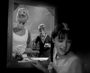 Instead Penny goes to a window that shows the other side of Judy's mirror.