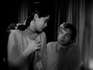 The boy tries to talk Penny into staying on this side of the mirror.