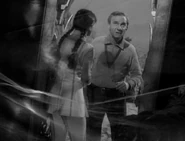 On the other side of the mirror, Penny can see Dr. Smith.