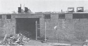 A fire-damaged building with a pile of ruined film cans