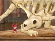 A screenshot of the pilot with Milli and the dinosaur skeleton.