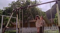 Alex plays on a swing set at 