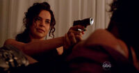 Ilana holds Sayid at gunpoint and claims that she was hired by Peter Avellino's family