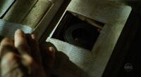 Locke discovers a hidden reel of film in the Bible