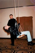 A backstage photo of Natalya on the swing, with Sergey Kalvarskiy in the background.