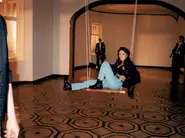 A backstage photo of Natalya on the swing, with the cellist in the background.