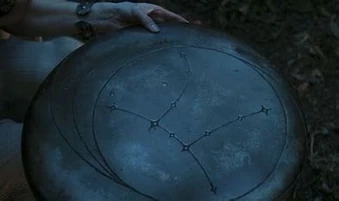 A carving of the Hermit's Hat upon a 's disc