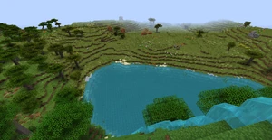 A waterfall, with camps in the distance.