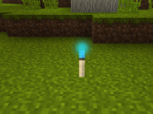 A Mallorn torch is placed on the ground of Lothlórien.