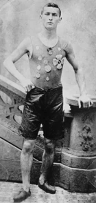 Not yet Houdini, Ehrich Weiss is shown exhibiting his competitive spirit and wearing medals he won as a member of the Pastime Athletic Club track team in New York circa 1890.