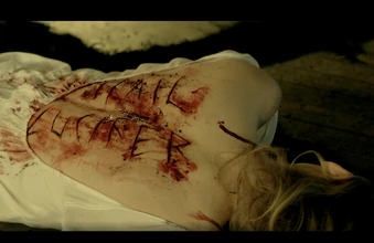  body at the theatre, with "Hail " carved on her back.