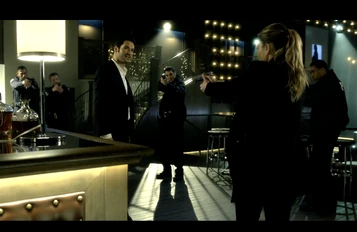  is surrounded by  as  pulls a gun on him upon seeing  body.