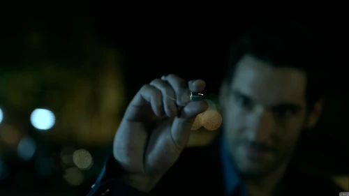 Lucifer takes advantage of the stopped time and removes the bullet.