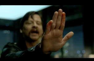 The same red paint on the warehouse is seen on  hand as he tries to high-five .