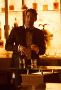 111 promo Lucifer pours drink