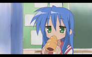 Konata eating a chocolate cornet.