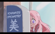 Miyuki banging her head on the sign at Yoshimizu Optometry