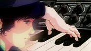 Minmay fiddles with the keyboard and plays Angel's Paints.